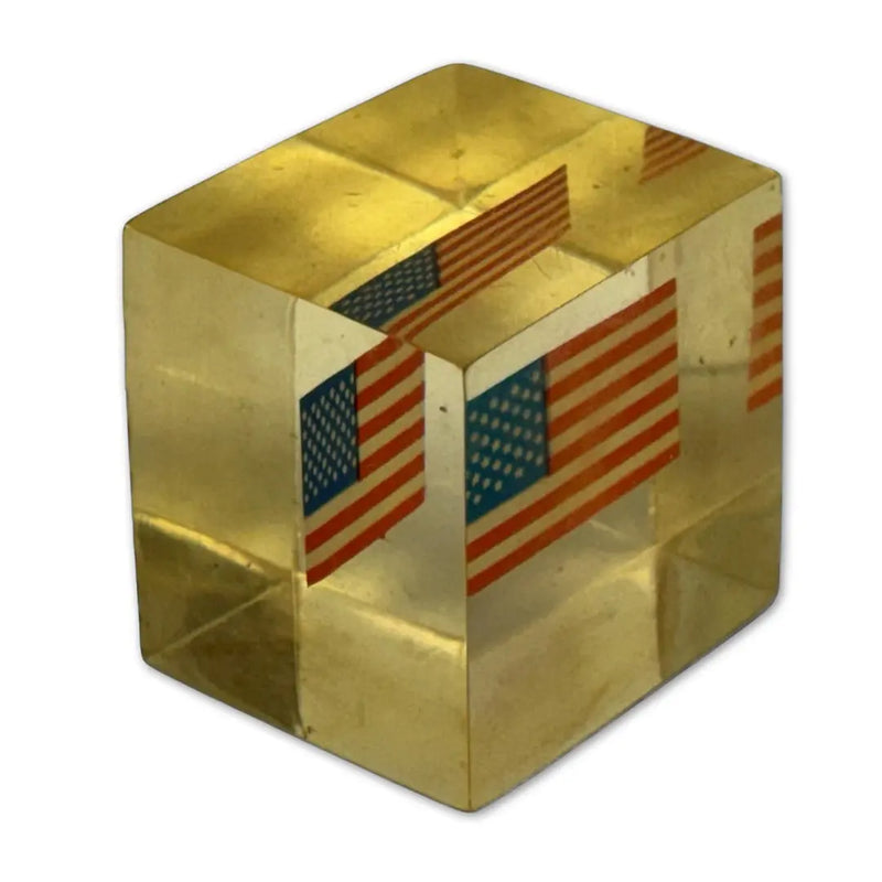 Vintage Lucite, acrylic, or resin paperweight with a US American flag embedded inside. Heritage Pastime
