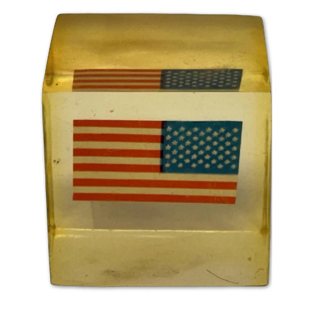 Vintage Lucite, acrylic, or resin paperweight with a US American flag embedded inside. Heritage Pastime